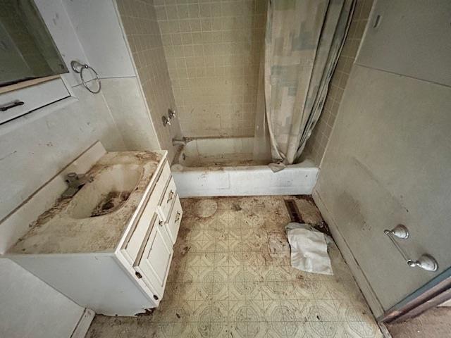 4992 Freeman Rd, Beaverton, MI 48612 - bathroom featuring vanity, shower / bath combo with shower curtain, and tile patterned floors