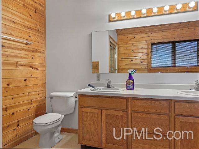 7730 Tipperary Ave, Gladstone, MI 49837 - full bathroom with toilet and vanity
