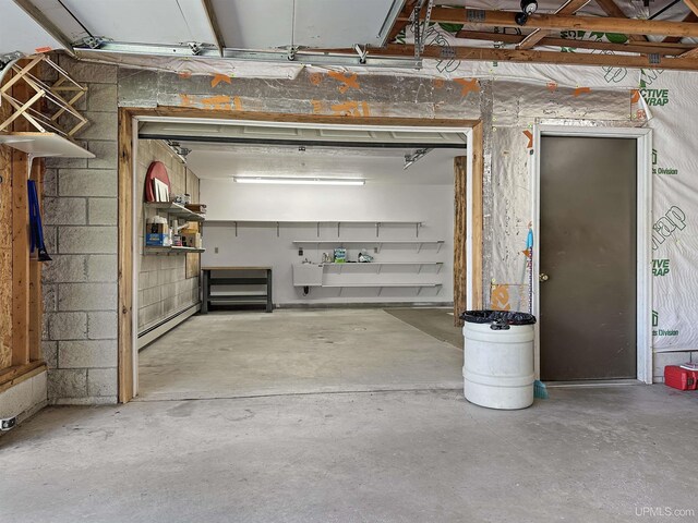 7730 Tipperary Ave, Gladstone, MI 49837 - garage featuring a baseboard heating unit