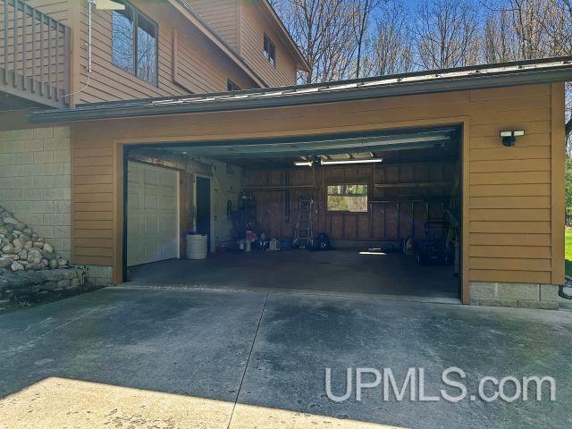 7730 Tipperary Ave, Gladstone, MI 49837 - garage featuring driveway