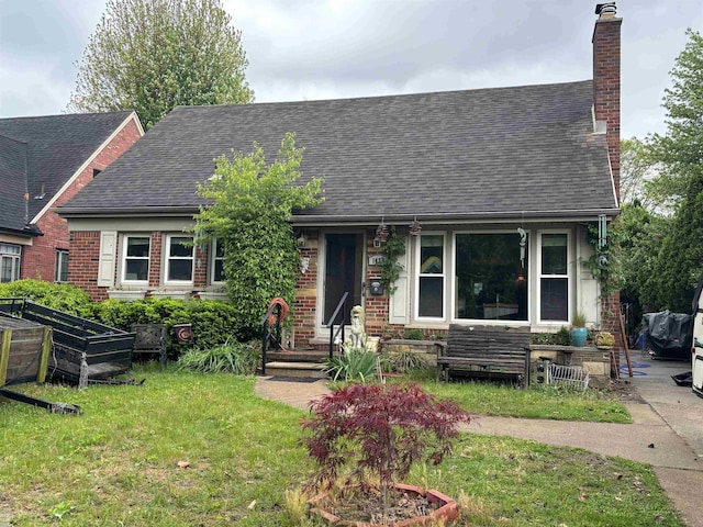 1433 Harvard Rd, Grosse Pointe, MI 48230 - view of front of home with a chimney, roof with shingles, a front yard, and brick siding