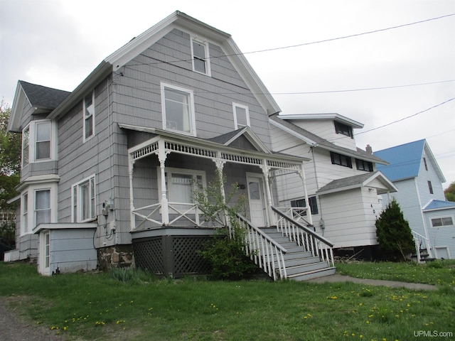 405 W S Ave Unit 1, Houghton, MI 49931 - view of front of house with covered porch, a front yard, and stairs