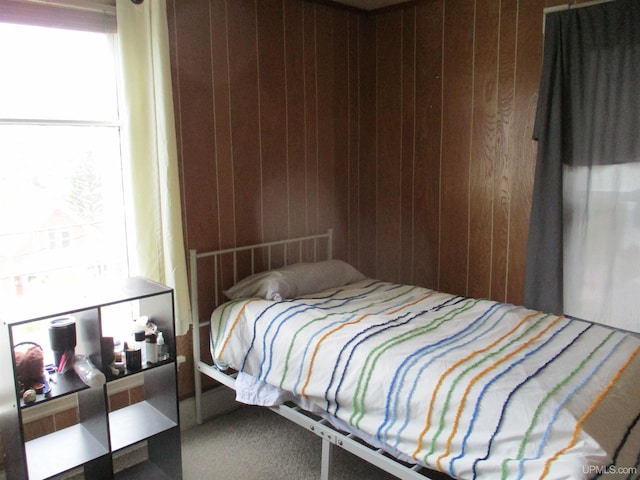 405 W S Ave Unit 1, Houghton, MI 49931 - carpeted bedroom featuring wooden walls and multiple windows