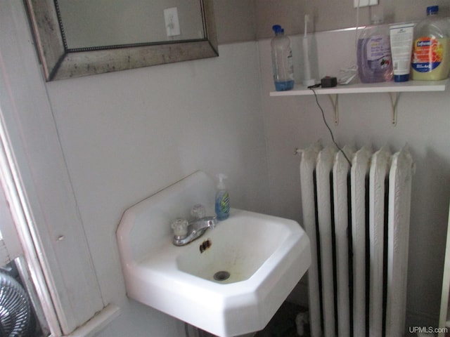 405 W S Ave Unit 1, Houghton, MI 49931 - bathroom featuring radiator heating unit and a sink