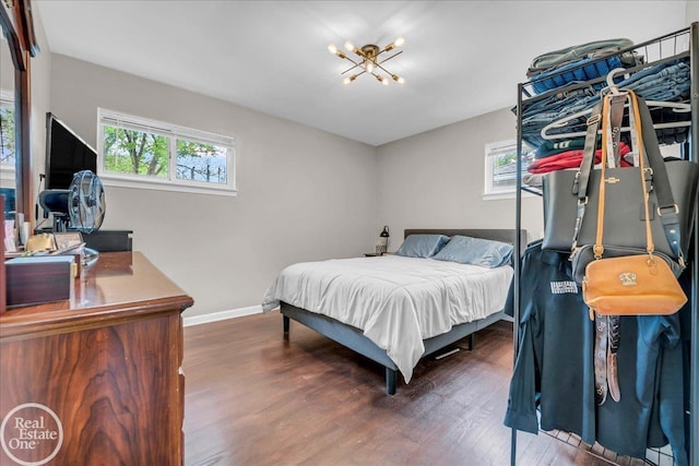 24080 Scotia Rd, Oak Park, MI 48237 - bedroom featuring wood finished floors, a chandelier, and baseboards