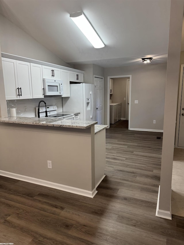 16180 Scenic Dr, Clinton, MI 48038 - kitchen featuring white appliances, separate washer and dryer, light stone countertops, white cabinetry, and lofted ceiling