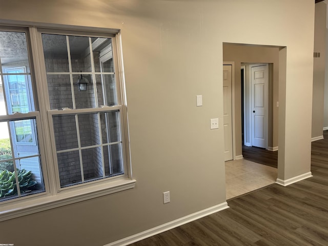 16180 Scenic Dr, Clinton, MI 48038 - hallway featuring wood finished floors, baseboards, and healthy amount of natural light