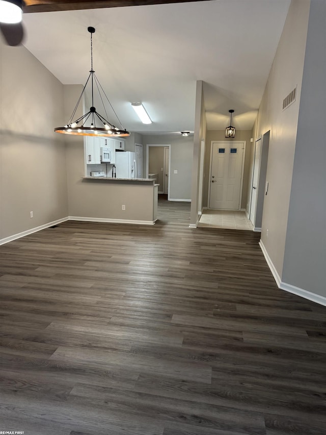 16180 Scenic Dr, Clinton, MI 48038 - unfurnished dining area with baseboards, a chandelier, and dark wood-style flooring