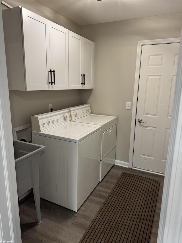16180 Scenic Dr, Clinton, MI 48038 - washroom featuring separate washer and dryer, cabinet space, dark wood-style floors, and baseboards