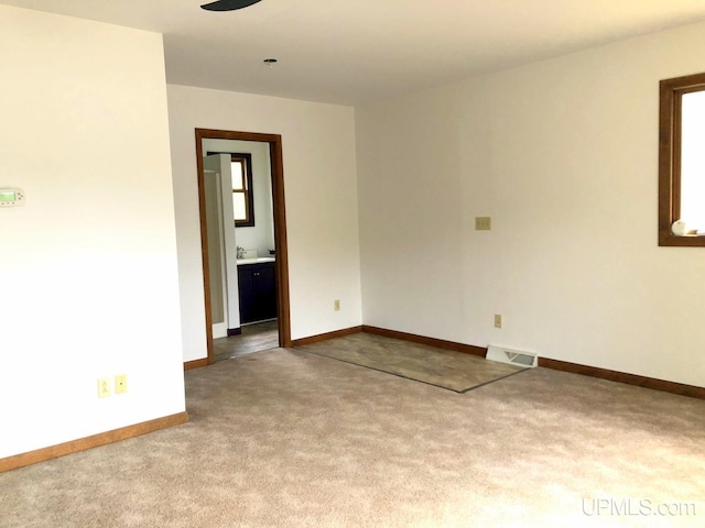 510 S Mackinac Ln, Gwinn, MI 49841 - spare room with carpet floors, ceiling fan, and baseboards