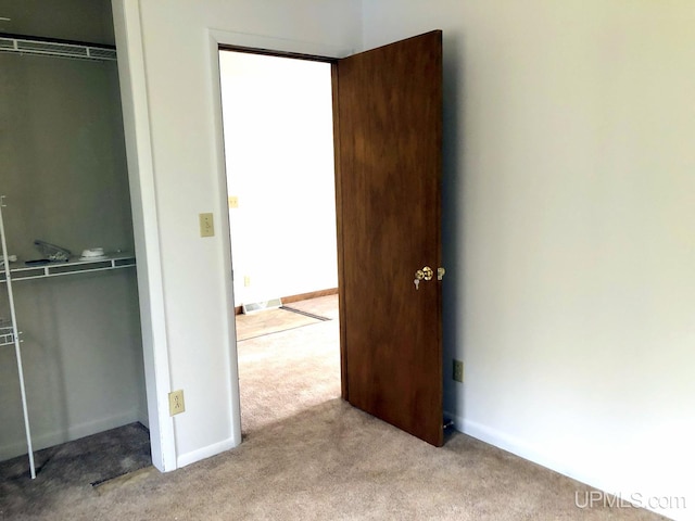 510 S Mackinac Ln, Gwinn, MI 49841 - unfurnished bedroom with a closet, carpet flooring, and baseboards