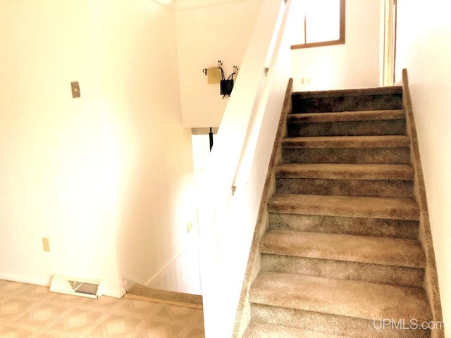510 S Mackinac Ln, Gwinn, MI 49841 - staircase featuring tile patterned floors and baseboards