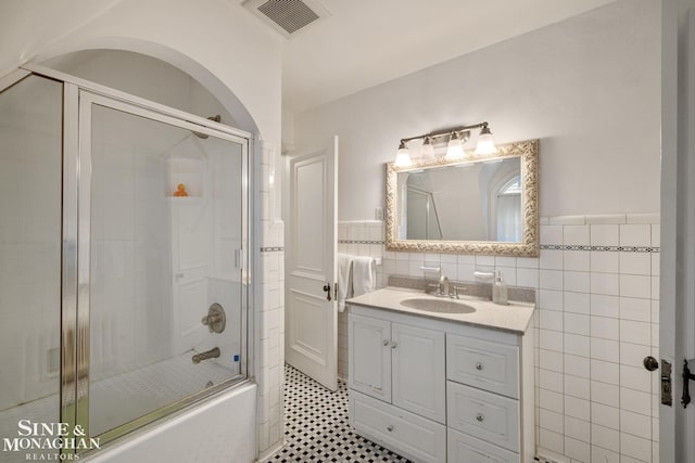 255 Lewiston Rd, Grosse Pointe Farms, MI 48236 - full bath with vanity, enclosed tub / shower combo, tile walls, and wainscoting