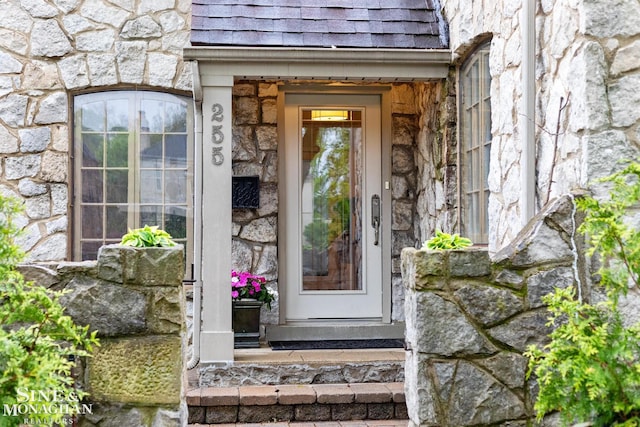 255 Lewiston Rd, Grosse Pointe Farms, MI 48236 - view of exterior entry with stone siding and a shingled roof