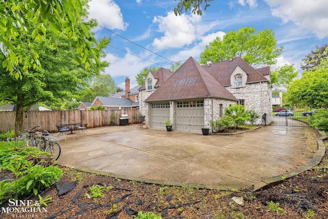 255 Lewiston Rd, Grosse Pointe Farms, MI 48236 - view of home's exterior featuring stone siding, a detached garage, and a shingled roof