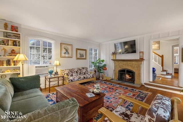255 Lewiston Rd, Grosse Pointe Farms, MI 48236 - living area featuring crown molding, wood finished floors, a warm lit fireplace, stairway, and cooling unit