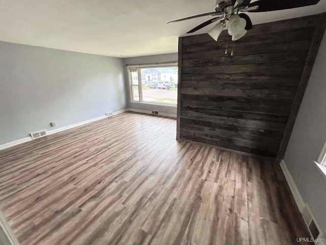 249 E Michigan Ave, Ironwood, MI 49938 - unfurnished room featuring wood finished floors, ceiling fan, and baseboards