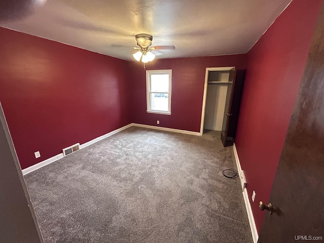 249 E Michigan Ave, Ironwood, MI 49938 - unfurnished bedroom with carpet flooring, baseboards, a closet, and ceiling fan
