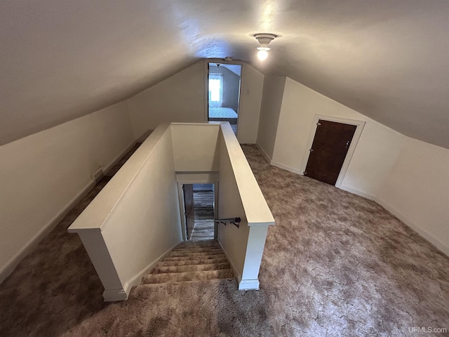 249 E Michigan Ave, Ironwood, MI 49938 - stairs with carpet floors and vaulted ceiling