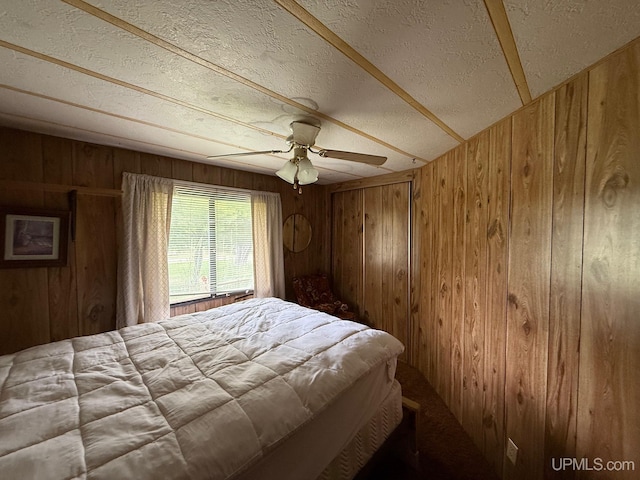 11843 Howen Rd, Long Lake T-Wi, WI 54542 - bedroom with wood walls, a textured ceiling, and ceiling fan