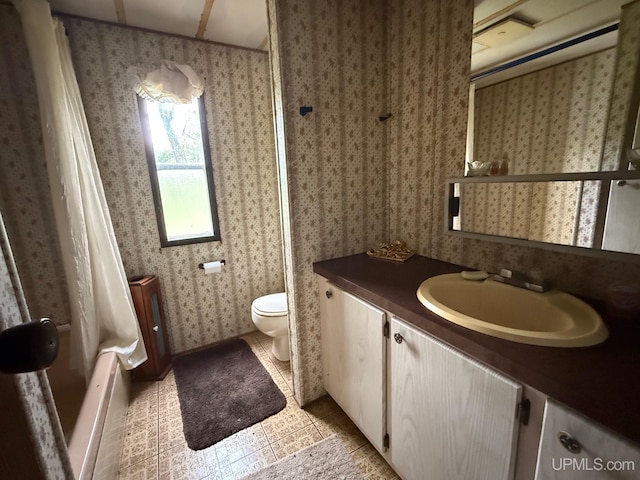 11843 Howen Rd, Long Lake T-Wi, WI 54542 - bathroom with vanity, wallpapered walls, toilet, tile patterned floors, and shower / tub combo with curtain