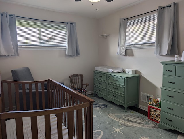 13610 Gander Ave, Warren, MI 48088 - carpeted bedroom featuring multiple windows, a crib, ceiling fan, and baseboards