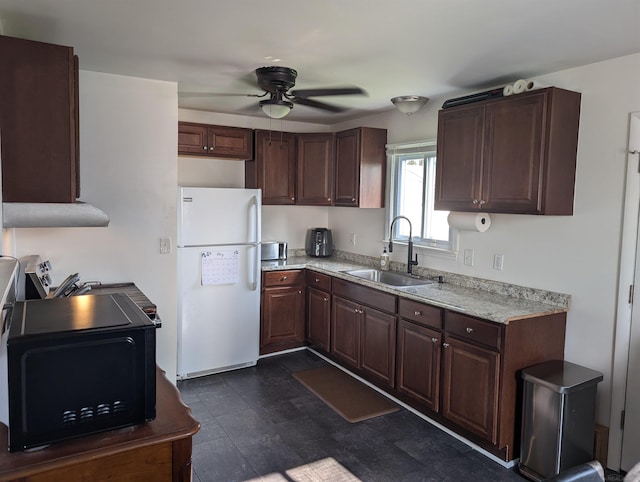 13610 Gander Ave, Warren, MI 48088 - kitchen with freestanding refrigerator, a sink, black microwave, ceiling fan, and dark brown cabinetry