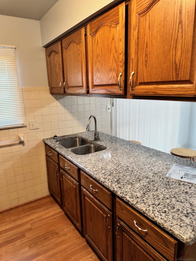 28724 Sutherland Dr, Warren, MI 48088 - kitchen with a sink, light wood-style floors, tile walls, light stone countertops, and wainscoting