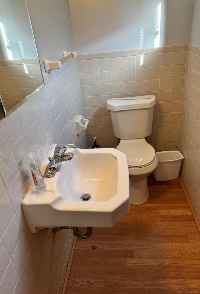 28724 Sutherland Dr, Warren, MI 48088 - bathroom featuring tile walls, a sink, toilet, plenty of natural light, and wood finished floors