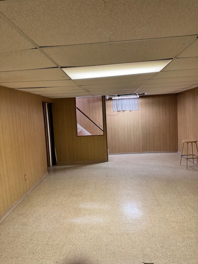 28724 Sutherland Dr, Warren, MI 48088 - finished below grade area featuring a paneled ceiling, light floors, and wooden walls
