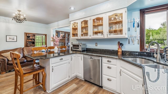 1128 E E St, Iron Mountain, MI 49801 - kitchen featuring dishwasher, a peninsula, a sink, white cabinetry, and glass insert cabinets