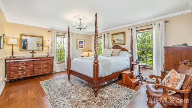 1128 E E St, Iron Mountain, MI 49801 - bedroom with a chandelier, multiple windows, wood finished floors, and ornamental molding
