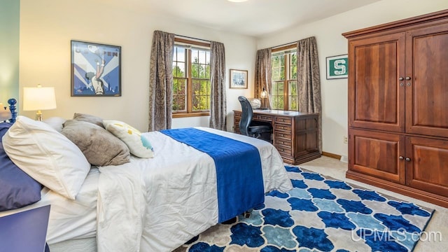 1128 E E St, Iron Mountain, MI 49801 - bedroom with baseboards and light colored carpet