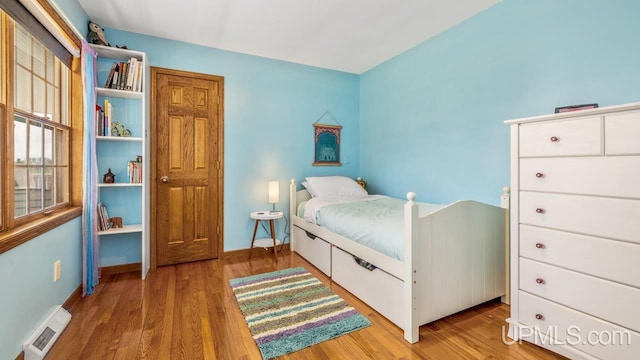 1128 E E St, Iron Mountain, MI 49801 - bedroom featuring wood finished floors and baseboards