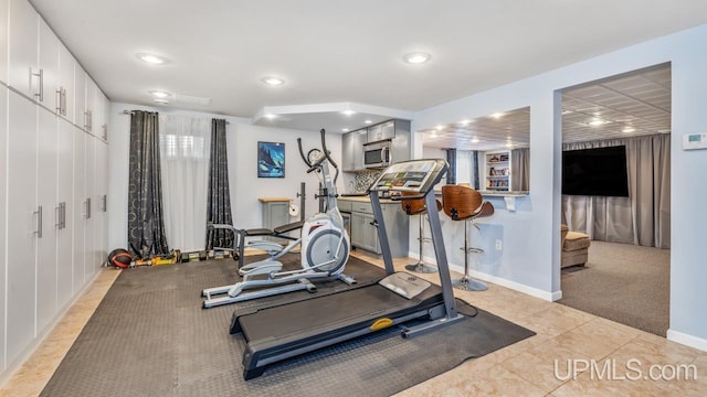 1128 E E St, Iron Mountain, MI 49801 - exercise room with recessed lighting, baseboards, light colored carpet, and light tile patterned floors