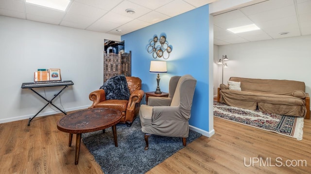1128 E E St, Iron Mountain, MI 49801 - sitting room featuring a paneled ceiling, wood finished floors, and baseboards