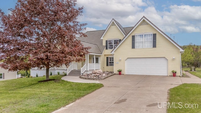 1128 E E St, Iron Mountain, MI 49801 - view of front of house featuring an attached garage, concrete driveway, and a front lawn