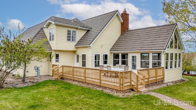 1128 E E St, Iron Mountain, MI 49801 - rear view of property featuring a chimney, a lawn, a deck, a sunroom, and roof with shingles