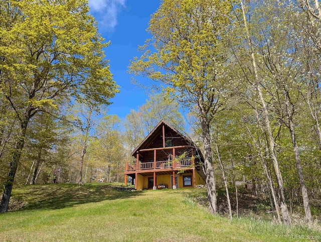 4537 Ii Rd, Garden, MI 49835 - rear view of house featuring a wooden deck and a lawn