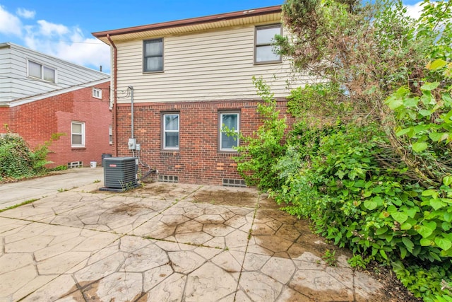20681 Beaufait St, Harper Woods, MI 48225 - back of property featuring a patio area, central AC, and brick siding