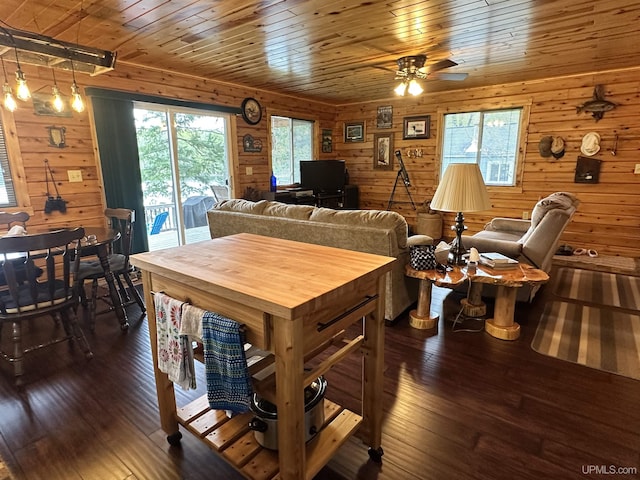 2966 Sycamore Ln, Republic, MI 49879 - dining space with dark wood-style floors, wooden ceiling, ceiling fan, and wooden walls