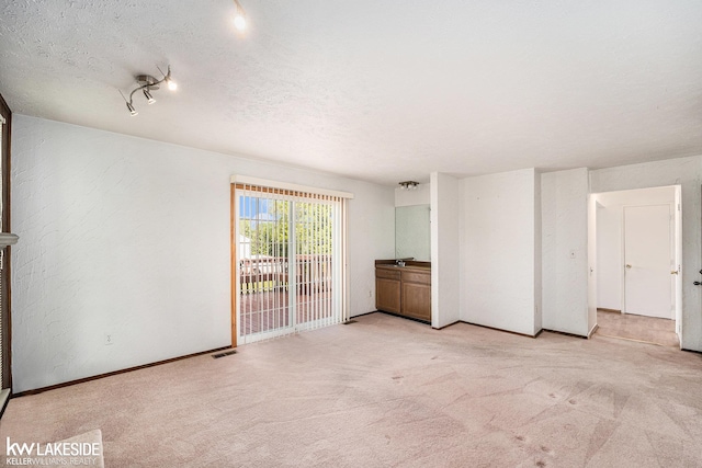 6019 Kingsfield Dr, West Bloomfield, MI 48322 - empty room featuring light carpet, baseboards, and a textured ceiling