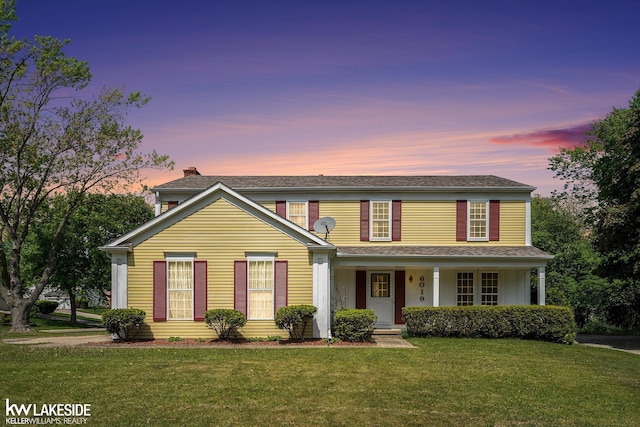 6019 Kingsfield Dr, West Bloomfield, MI 48322 - traditional-style home featuring a front yard, a chimney, and covered porch
