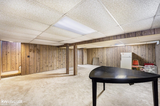 6019 Kingsfield Dr, West Bloomfield, MI 48322 - finished basement with freestanding refrigerator, a paneled ceiling, carpet floors, and wooden walls