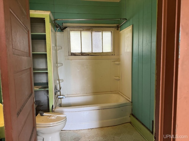 2003 Center St, Marquette, MI 49855 - bathroom featuring toilet, wooden walls, and bathing tub / shower combination