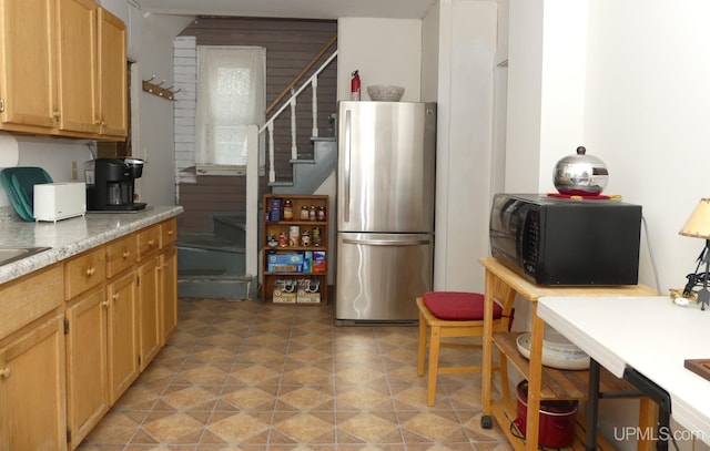 22019 E Everett Ave, Grand Marais, MI 49839 - kitchen with freestanding refrigerator, black microwave, light countertops, and light floors