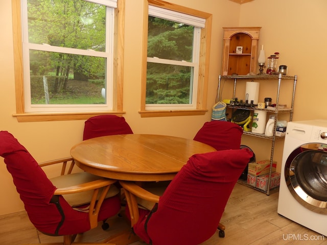 22019 E Everett Ave, Grand Marais, MI 49839 - dining space with washer / dryer, plenty of natural light, and wood finished floors