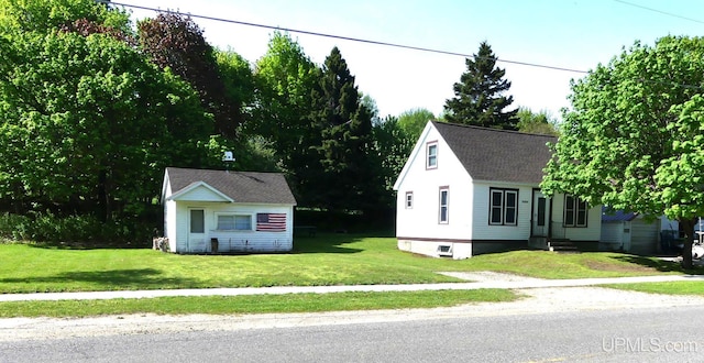 22019 E Everett Ave, Grand Marais, MI 49839 - view of front of house with a front yard and a shingled roof