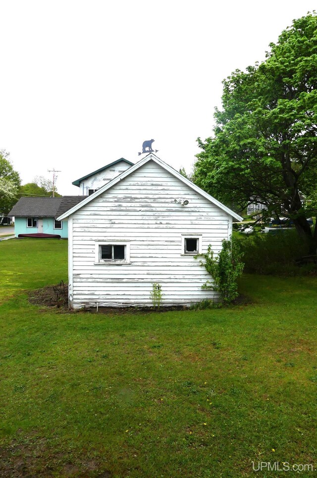22019 E Everett Ave, Grand Marais, MI 49839 - view of side of home with a lawn
