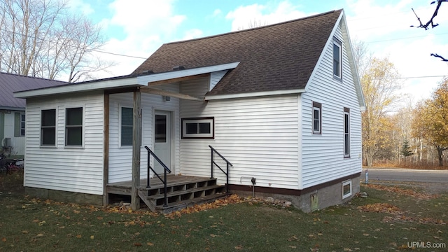22019 E Everett Ave, Grand Marais, MI 49839 - rear view of property with roof with shingles and a yard